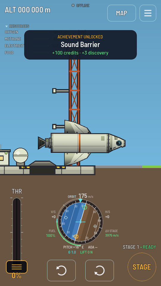 The same rocket toppled onto its side on flat ground next to the launch pad.
