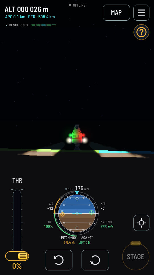 A small lander standing on the ground at night, a red light on one flank and a green one on the other tinting its hull, and a floodlight on each side throwing its beam down onto the ground beside it, where two bright patches of grass and sand stand out of the dark.